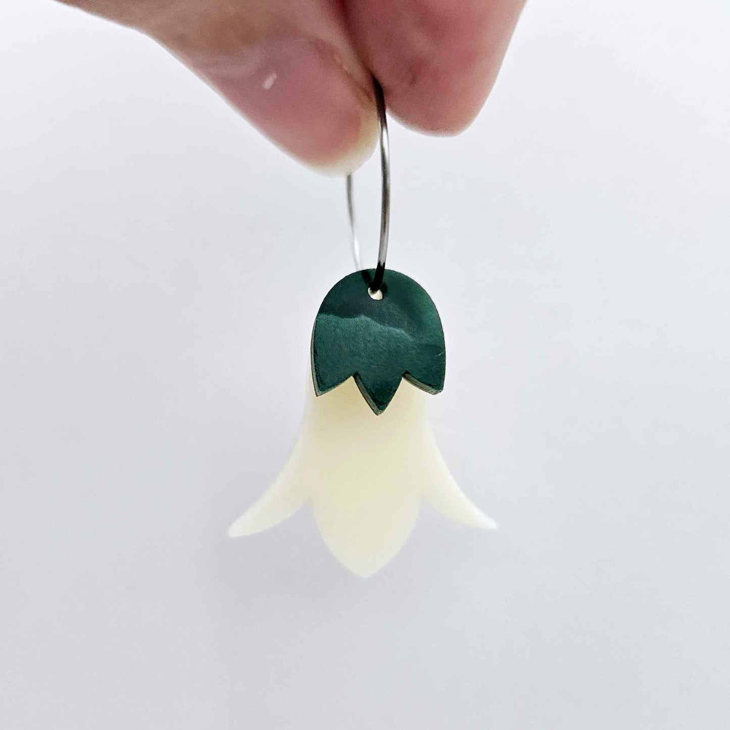 Cream acrylic nodding flower dangle blanks assembled on 20mm hoops with leaf cap detail for a layered botanical flower look