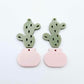 Two-piece cactus dangle blanks in olive green and strawberry milkshake pink, shown unassembled with cactus top and pot bottom pieces laid flat