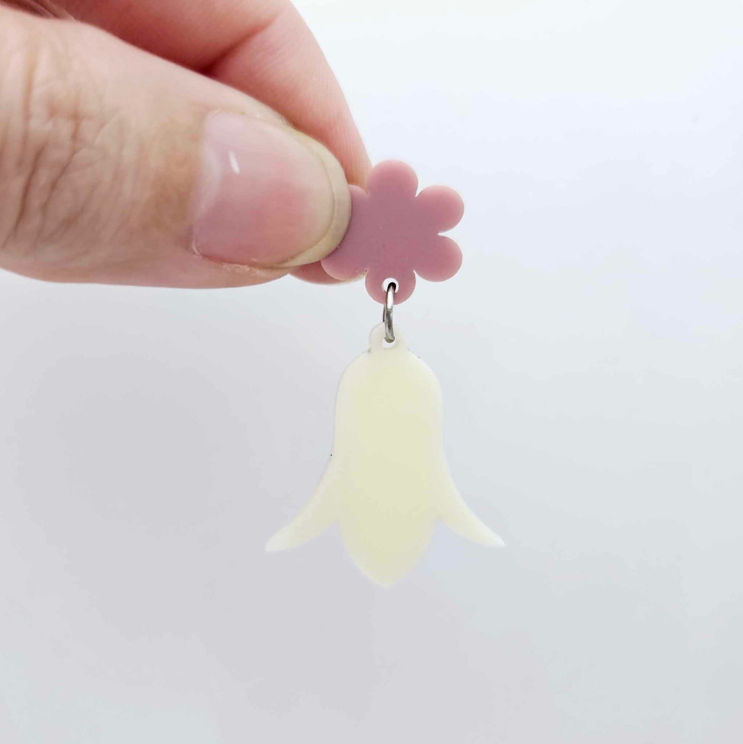 28mm cream acrylic nodding flower dangle hanging from a 14mm flower topper, shown as a completed earring design