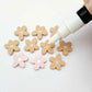 16mm dusty pale pink organic flower stud blanks showing paint filled white example and unfilled pieces with protective film, pictured with a white Posca paint pen