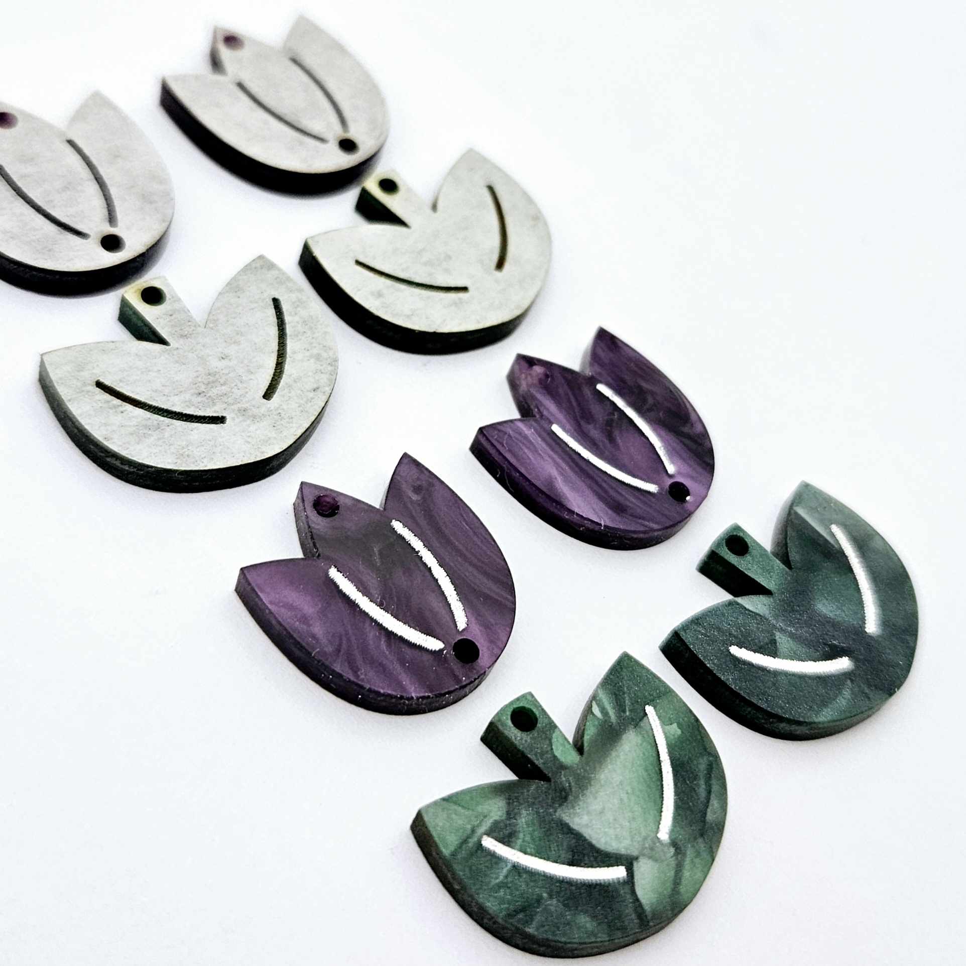Two-piece tulip acrylic dangle blanks in purple marble and green mineral acrylic, paint filled white on one pair with remaining pair unfilled