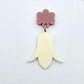 28mm cream acrylic nodding flower dangle hanging from a 14mm flower topper, shown as a completed earring design