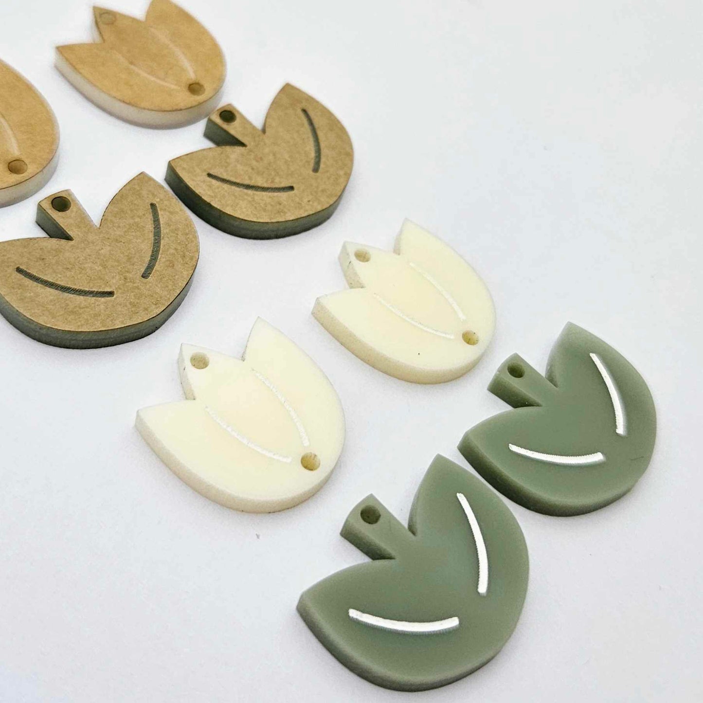 Cream and olive green acrylic tulip dangle blanks, one pair paint filled white and one pair with protective paper on, shown as a two-piece floral design
