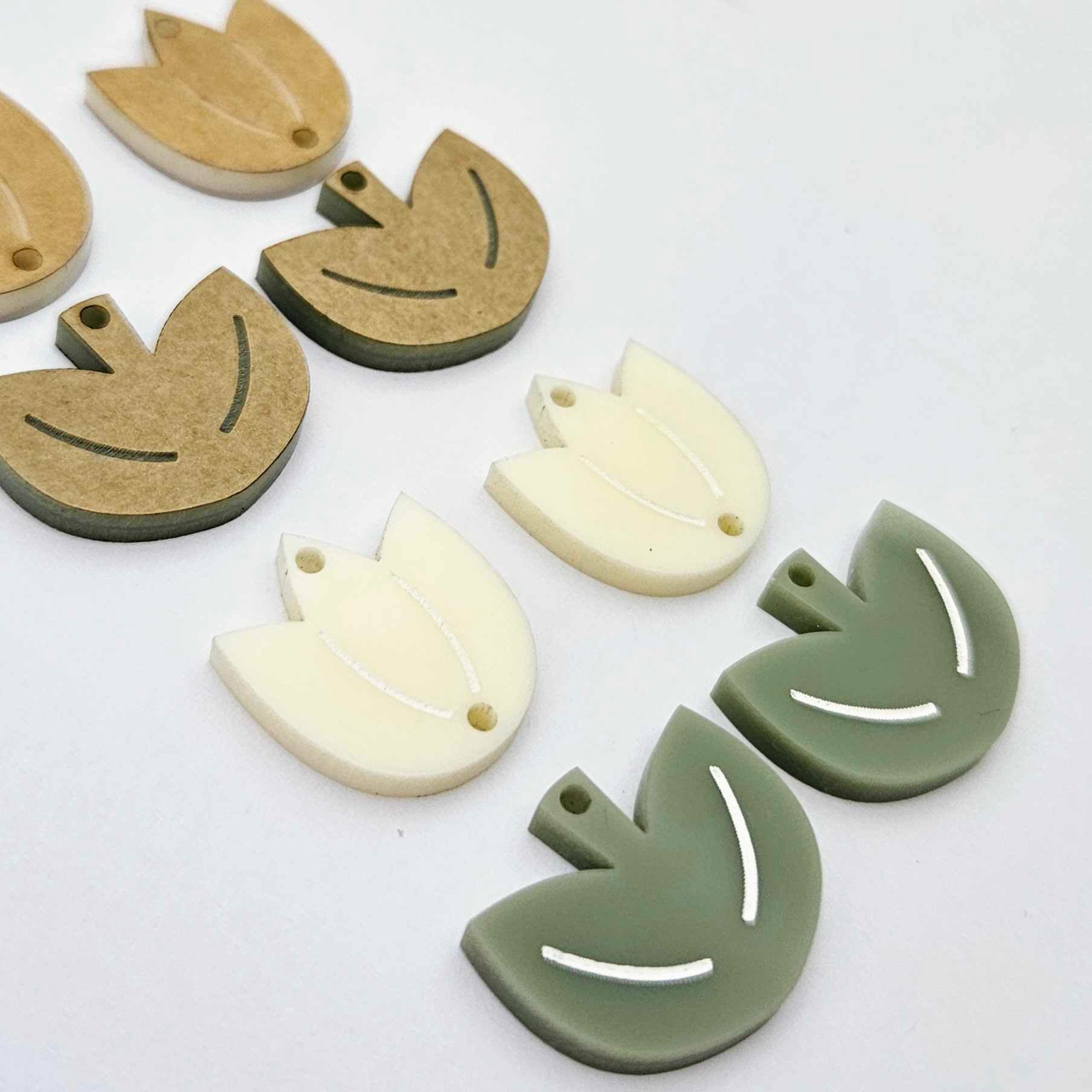Cream and olive green acrylic tulip dangle blanks, one pair paint filled white and one pair with protective paper on, shown as a two-piece floral design