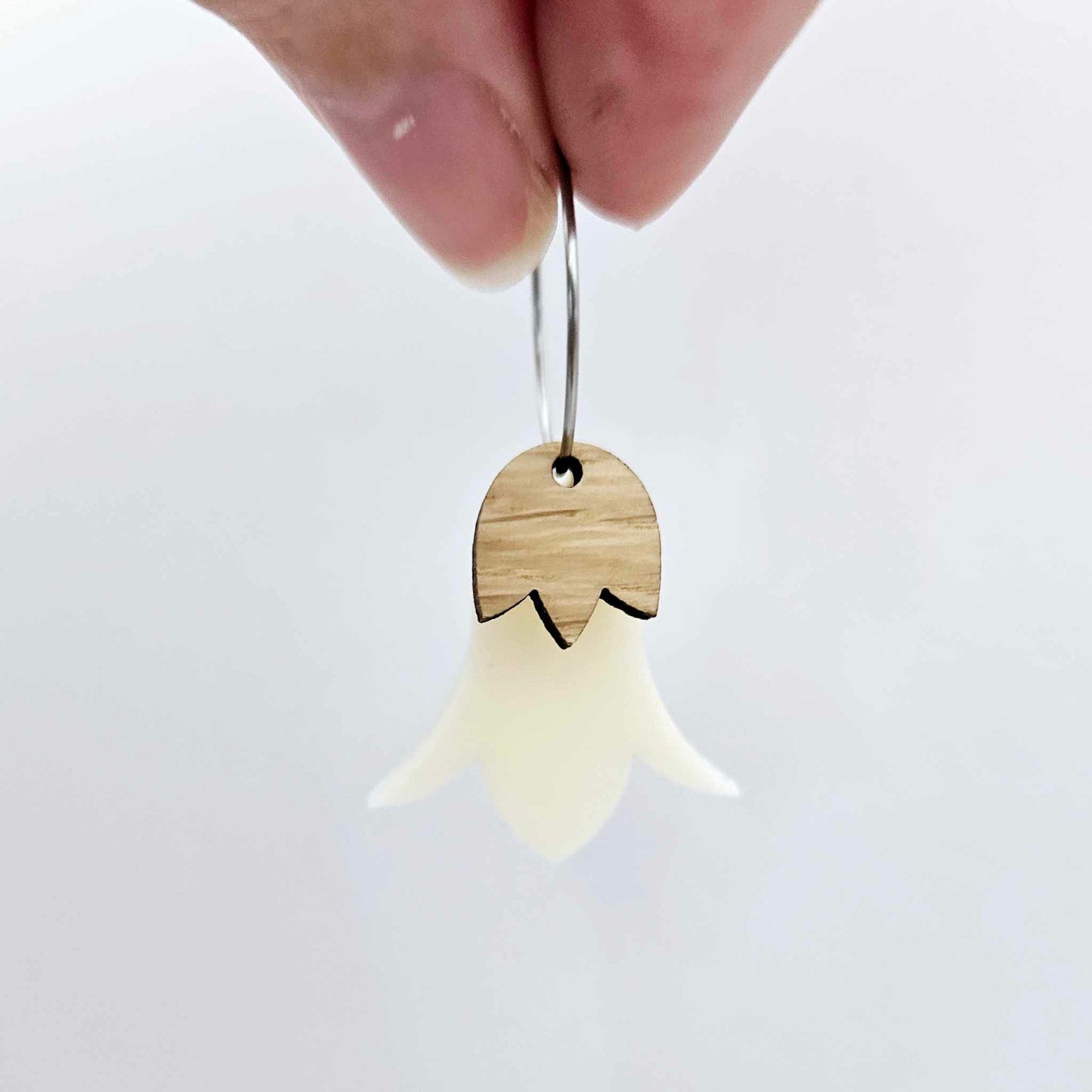 Cream acrylic nodding flower dangle blanks assembled on 20mm hoops with leaf cap detail for a layered botanical flower look