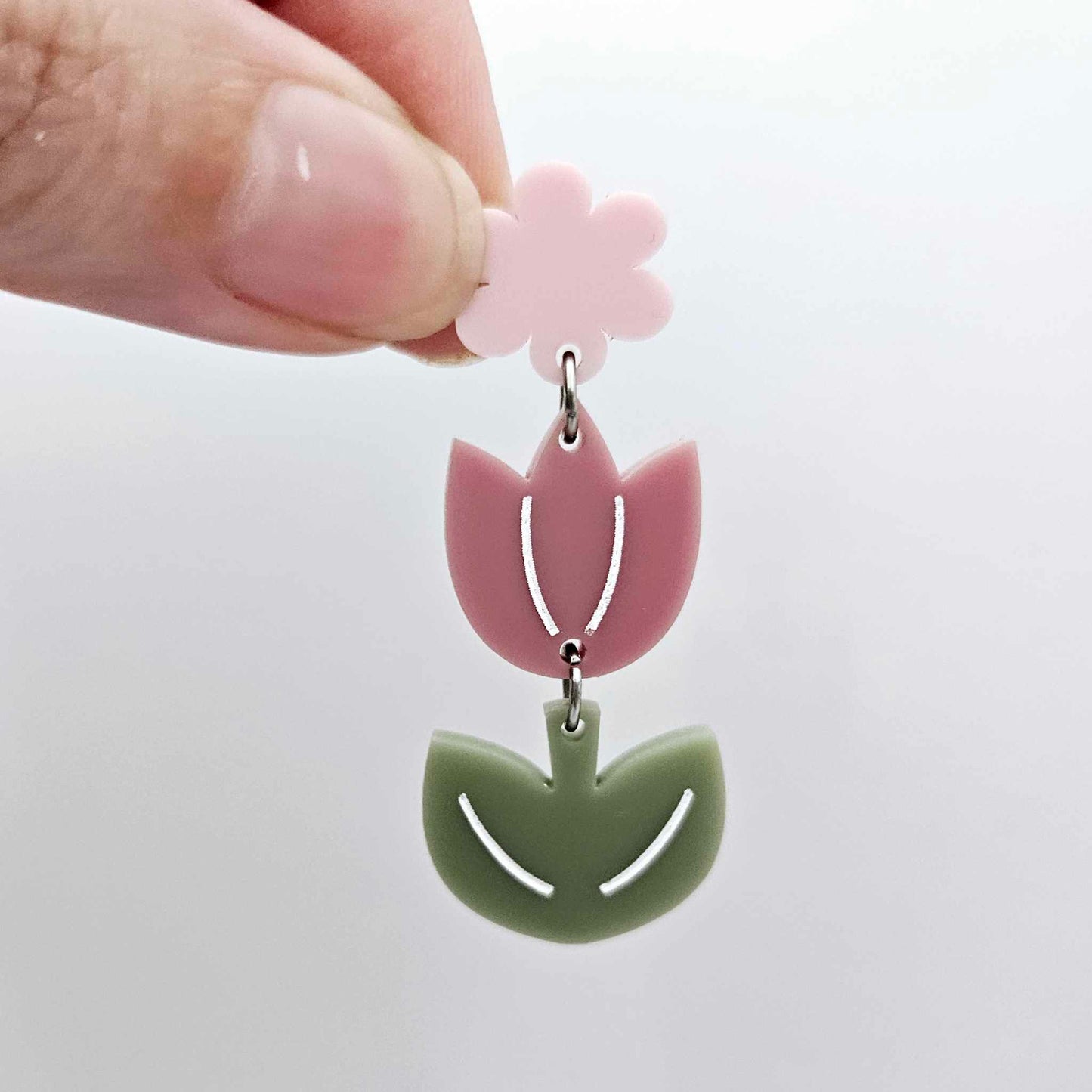 Assembled dusty rose and olive green tulip dangle hanging from a 14mm flower topper, engraved detail paint filled white