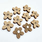 16mm iced coffee brown organic flower stud blanks with engraved centre, one pair paint filled white and several unfilled pieces shown with protective film on