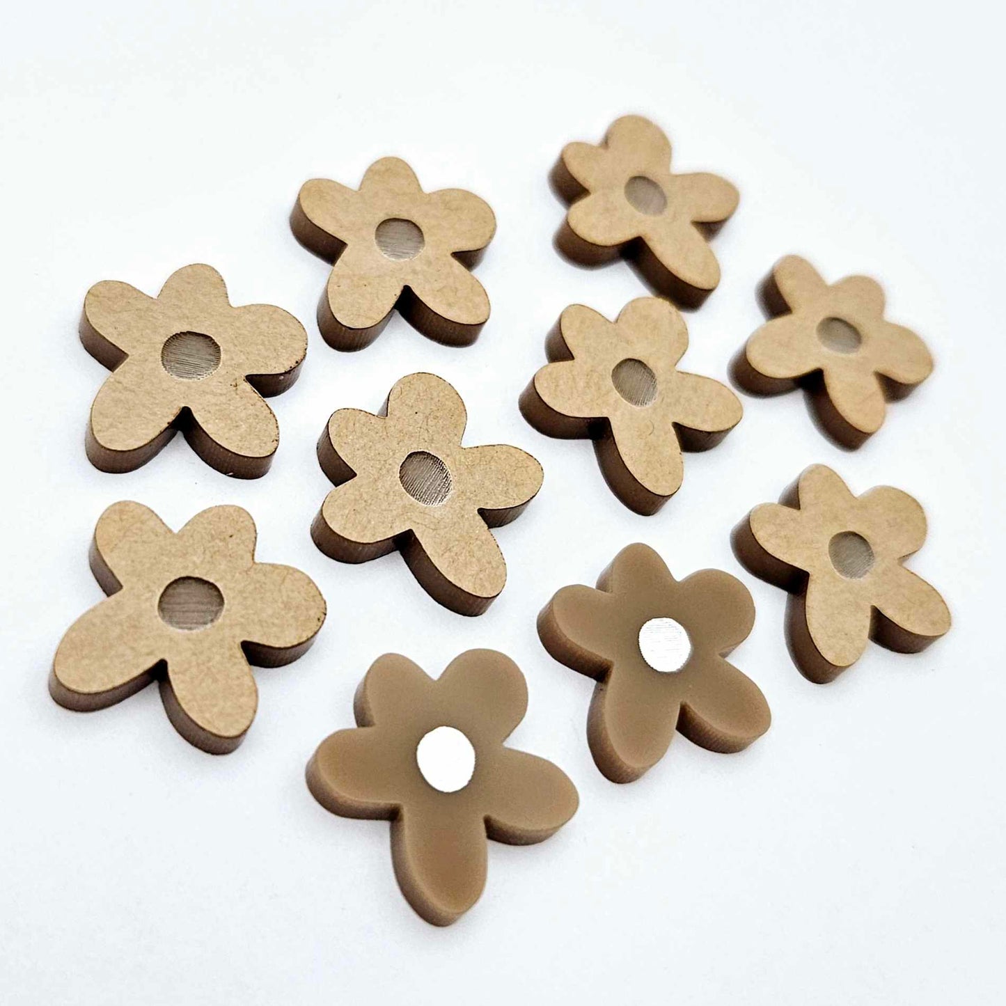 16mm iced coffee brown organic flower stud blanks with engraved centre, one pair paint filled white and several unfilled pieces shown with protective film on