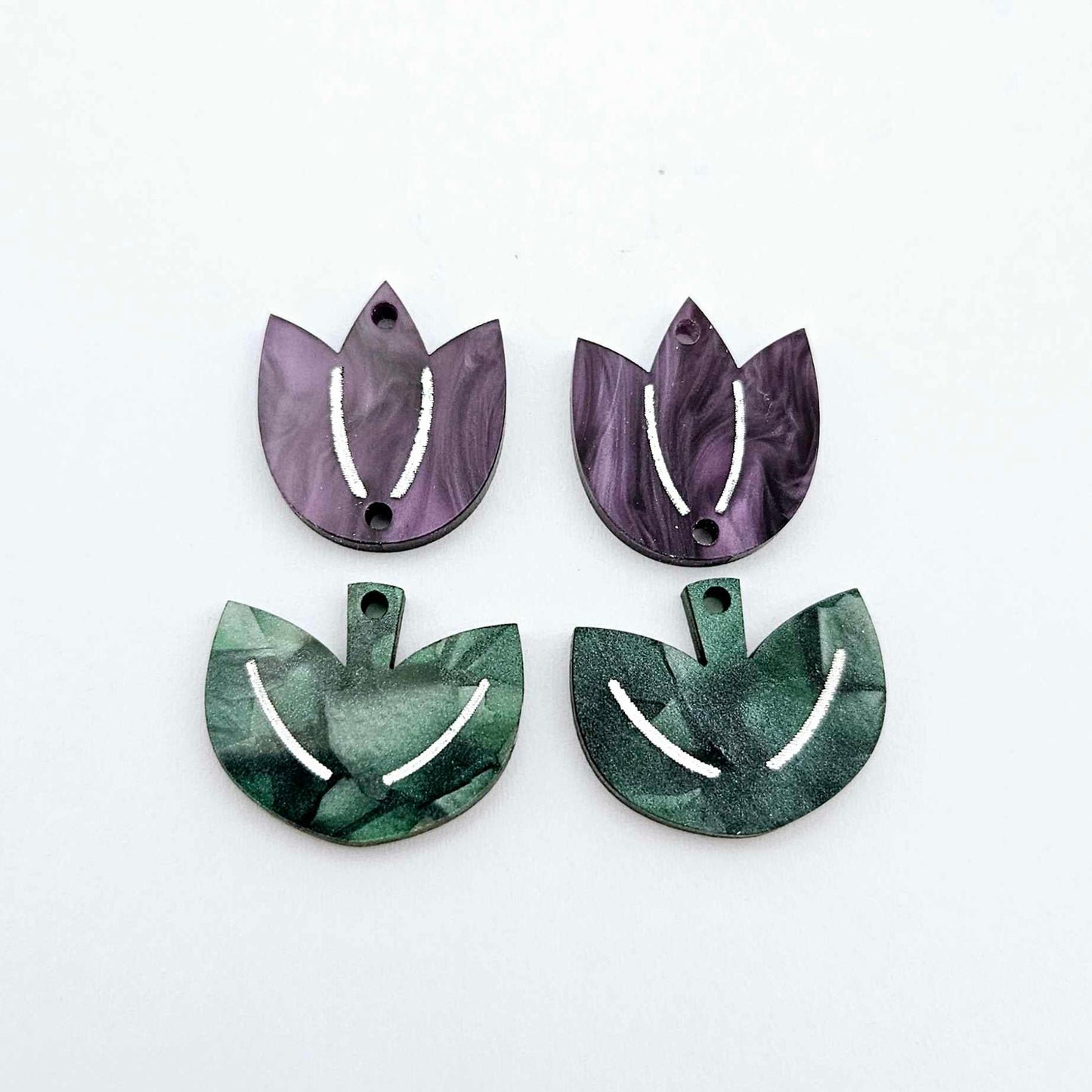 Two-piece tulip acrylic dangle blanks in purple marble and green mineral acrylic, paint filled white on one pair
