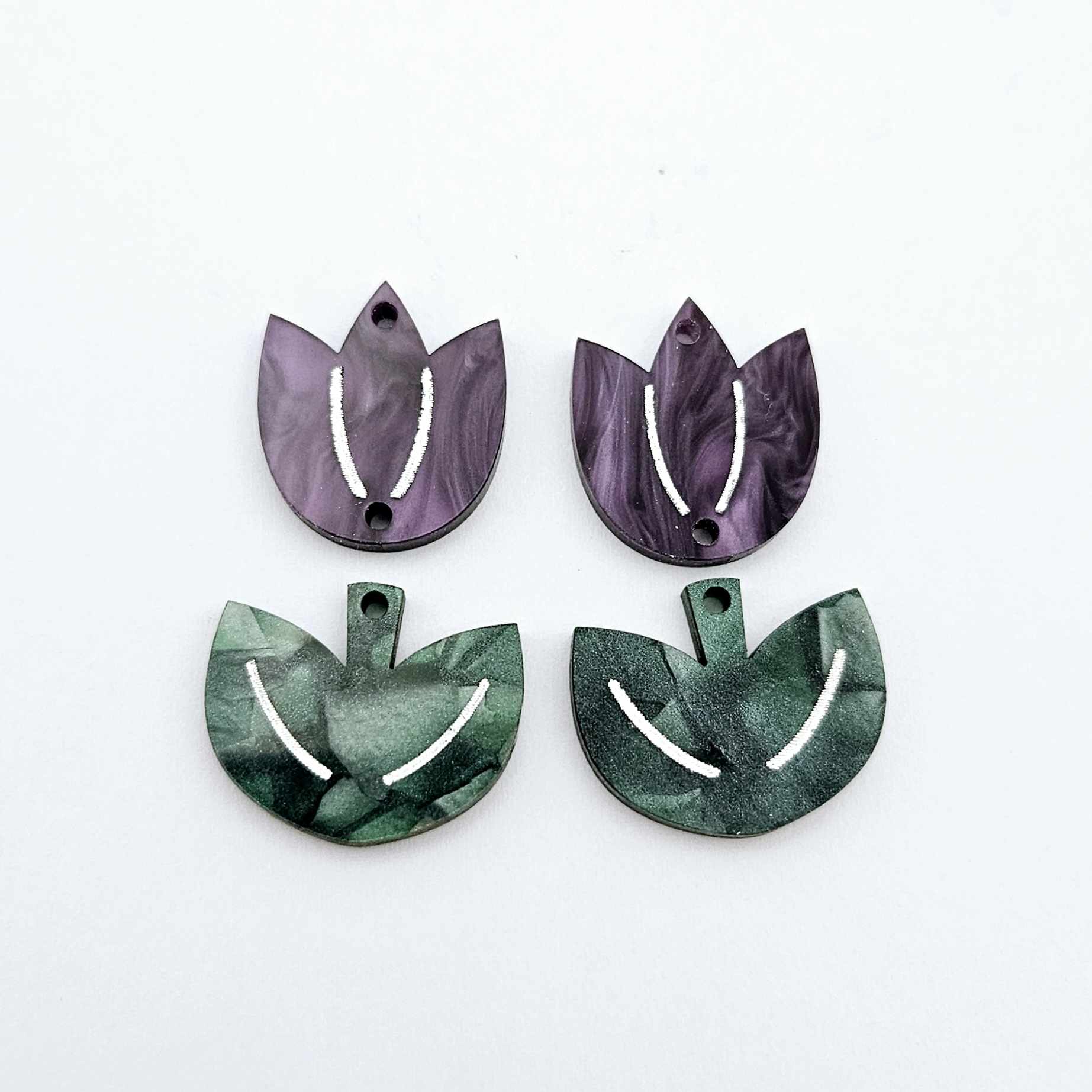 Two-piece tulip acrylic dangle blanks in purple marble and green mineral acrylic, paint filled white on one pair