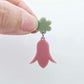 28mm dusty rose acrylic nodding flower dangle hanging from a 14mm flower topper, shown as a completed earring design