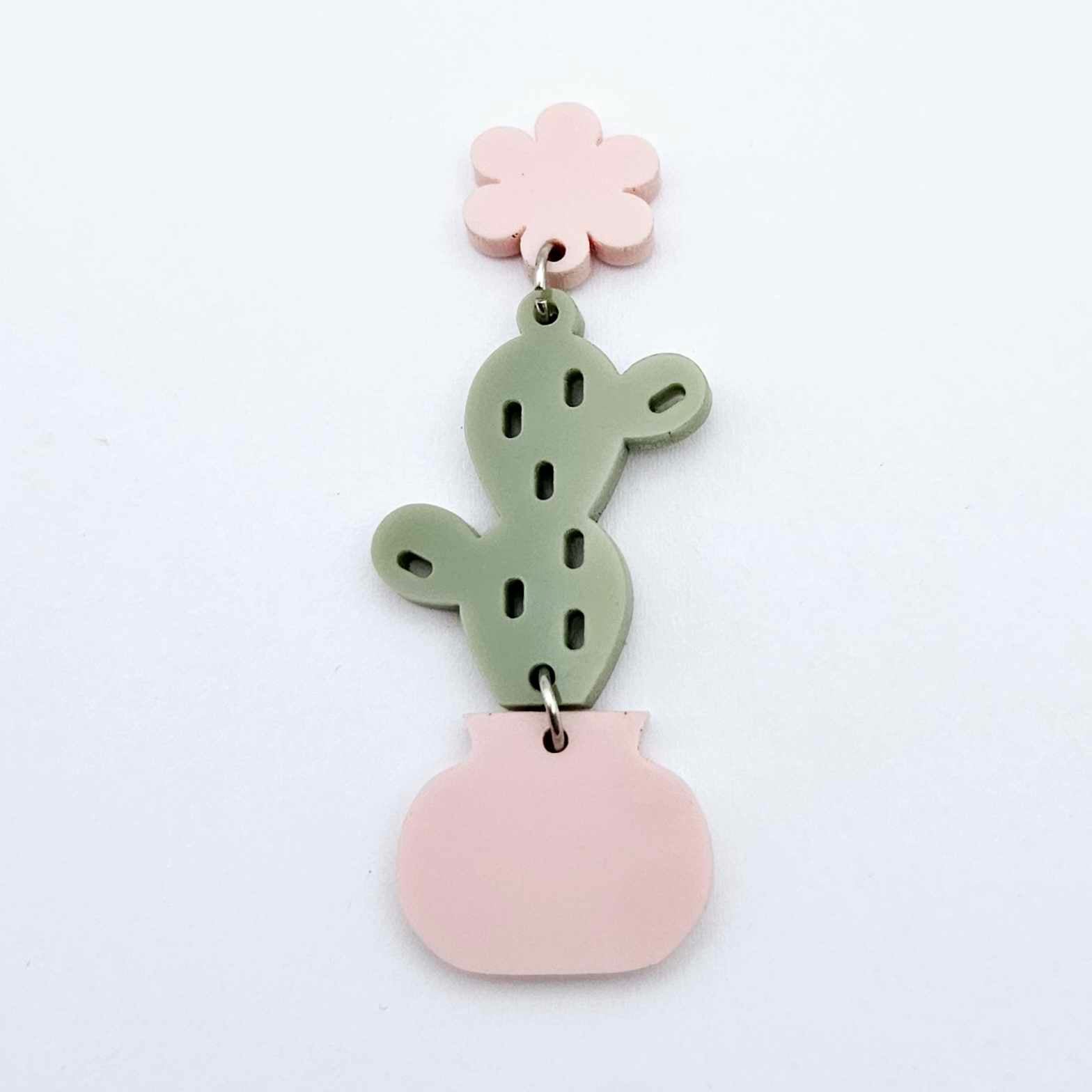 Assembled olive green acrylic cactus and pink pot dangle hanging from a 14mm strawberry milkshake flower topper