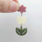 Assembled cream and olive green acrylic tulip dangle hanging from a 14mm flower topper, engraved detail paint filled white