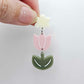 Assembled dusty pale pink and olive green acrylic tulip dangle hanging from a 14mm flower topper, engraved detail paint filled white