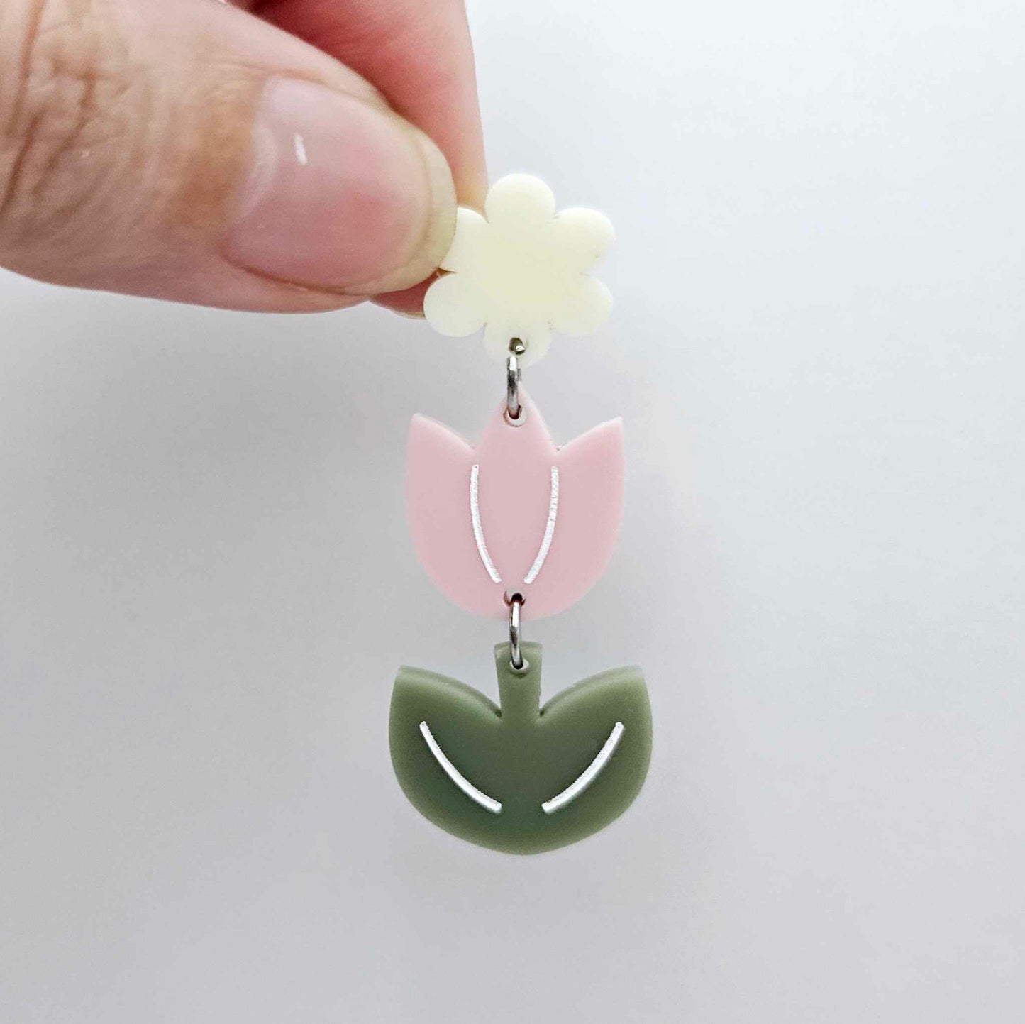 Assembled dusty pale pink and olive green acrylic tulip dangle hanging from a 14mm flower topper, engraved detail paint filled white