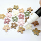 16mm mixed earthy tone acrylic organic flower stud blanks with engraved centre paint filled white, shown with a white Posca Paint Pen