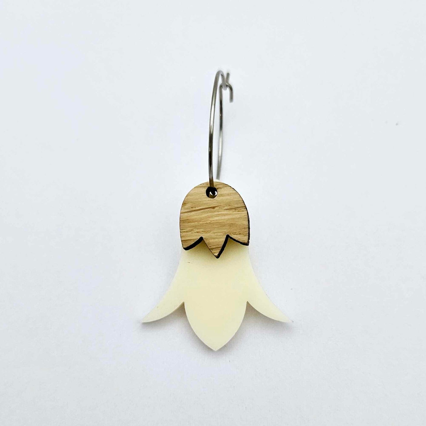 Cream acrylic nodding flower dangle blanks assembled on 20mm hoops with leaf cap detail for a layered botanical flower look