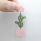 Assembled olive green acrylic cactus and pink pot dangle hanging from a 14mm strawberry milkshake flower topper
