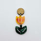 Assembled orange artist swirl and green mineral acrylic tulip dangle hanging from a 14mm oak wood topper, engraved detail paint filled white