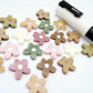 16mm mixed earthy tone acrylic organic flower stud blanks with engraved centre paint filled white, shown with a white Posca Paint Pen