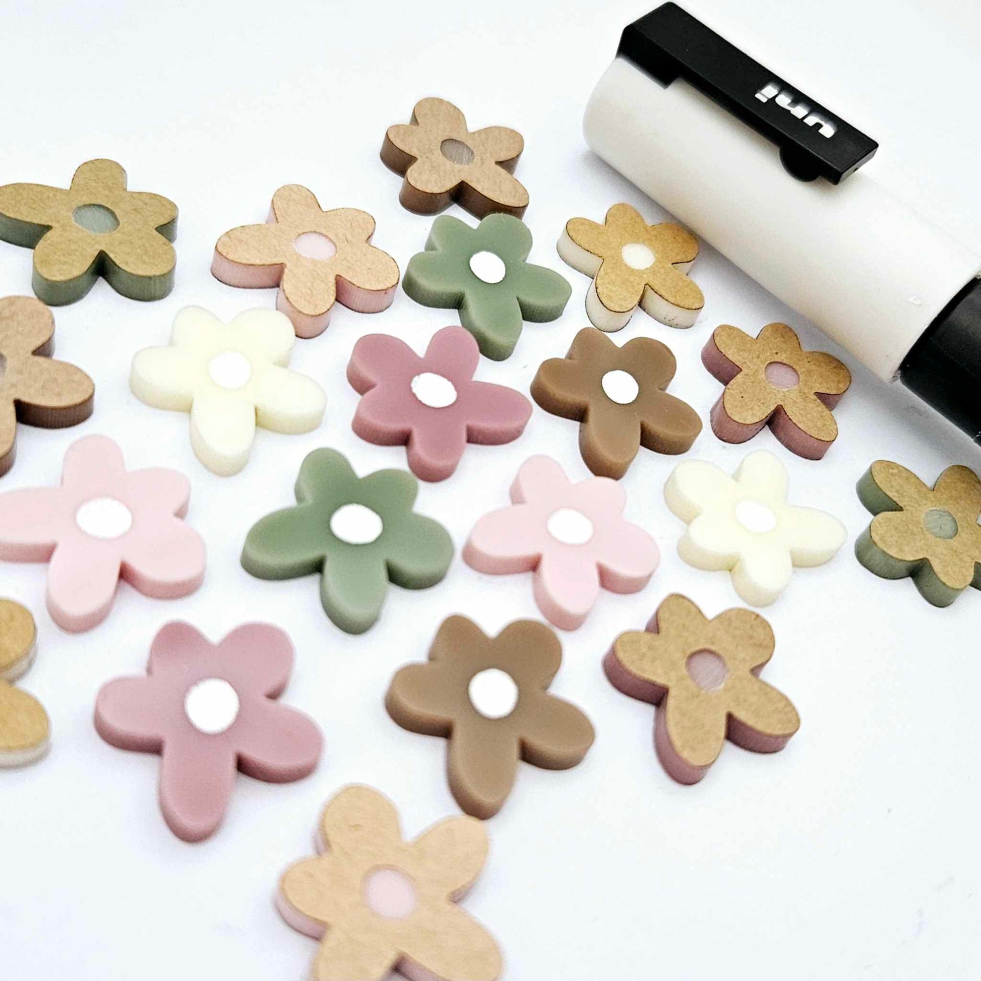 16mm mixed earthy tone acrylic organic flower stud blanks with engraved centre paint filled white, shown with a white Posca Paint Pen