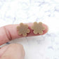 Two 14mm iced coffee brown flower stud blanks, shown on a finger for size reference