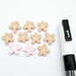16mm dusty pale pink organic flower stud blanks showing paint filled white example and unfilled pieces with protective film, pictured with a white Posca paint pen