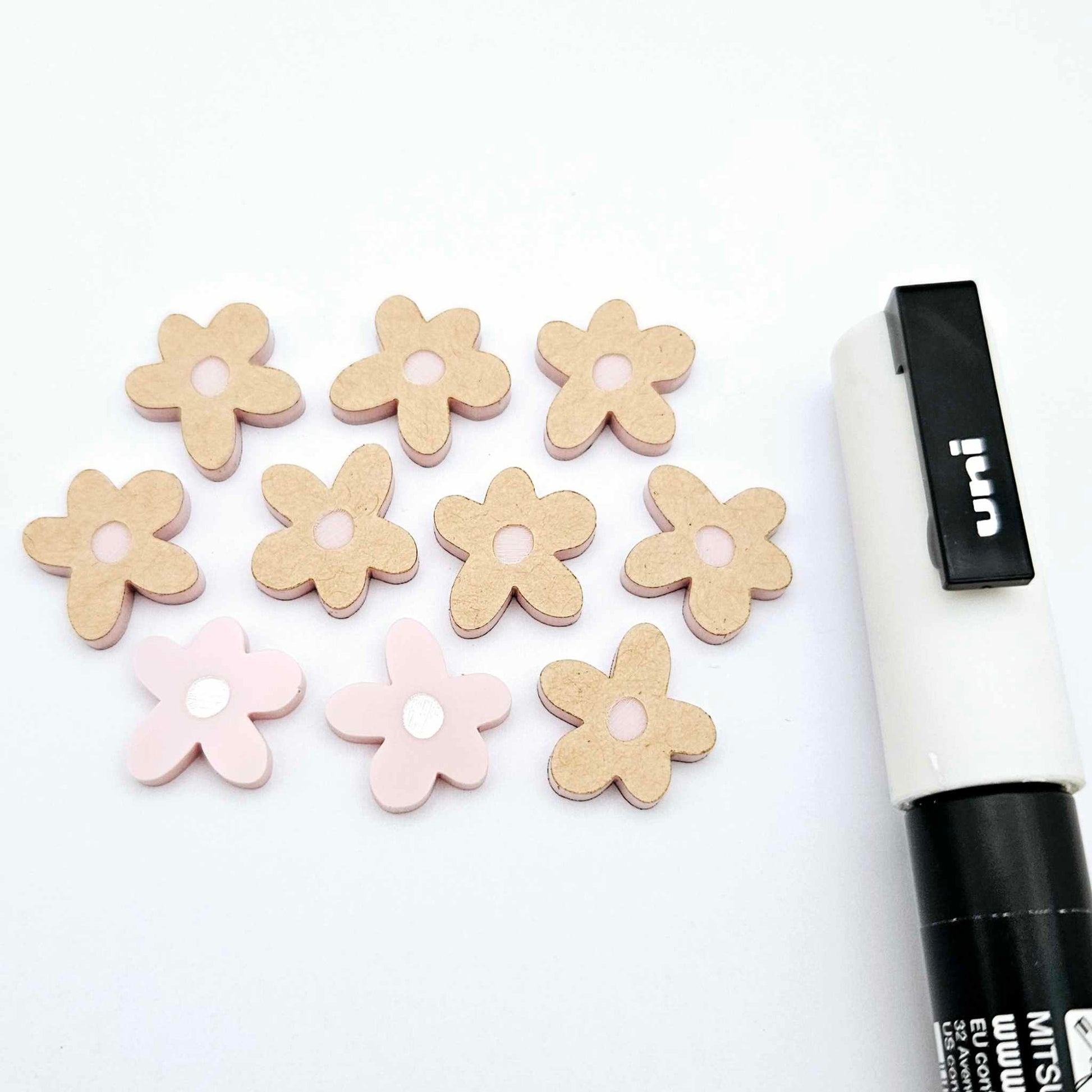 16mm dusty pale pink organic flower stud blanks showing paint filled white example and unfilled pieces with protective film, pictured with a white Posca paint pen