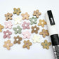16mm mixed earthy tone acrylic organic flower stud blanks with engraved centre paint filled white, shown with a white Posca Paint Pen