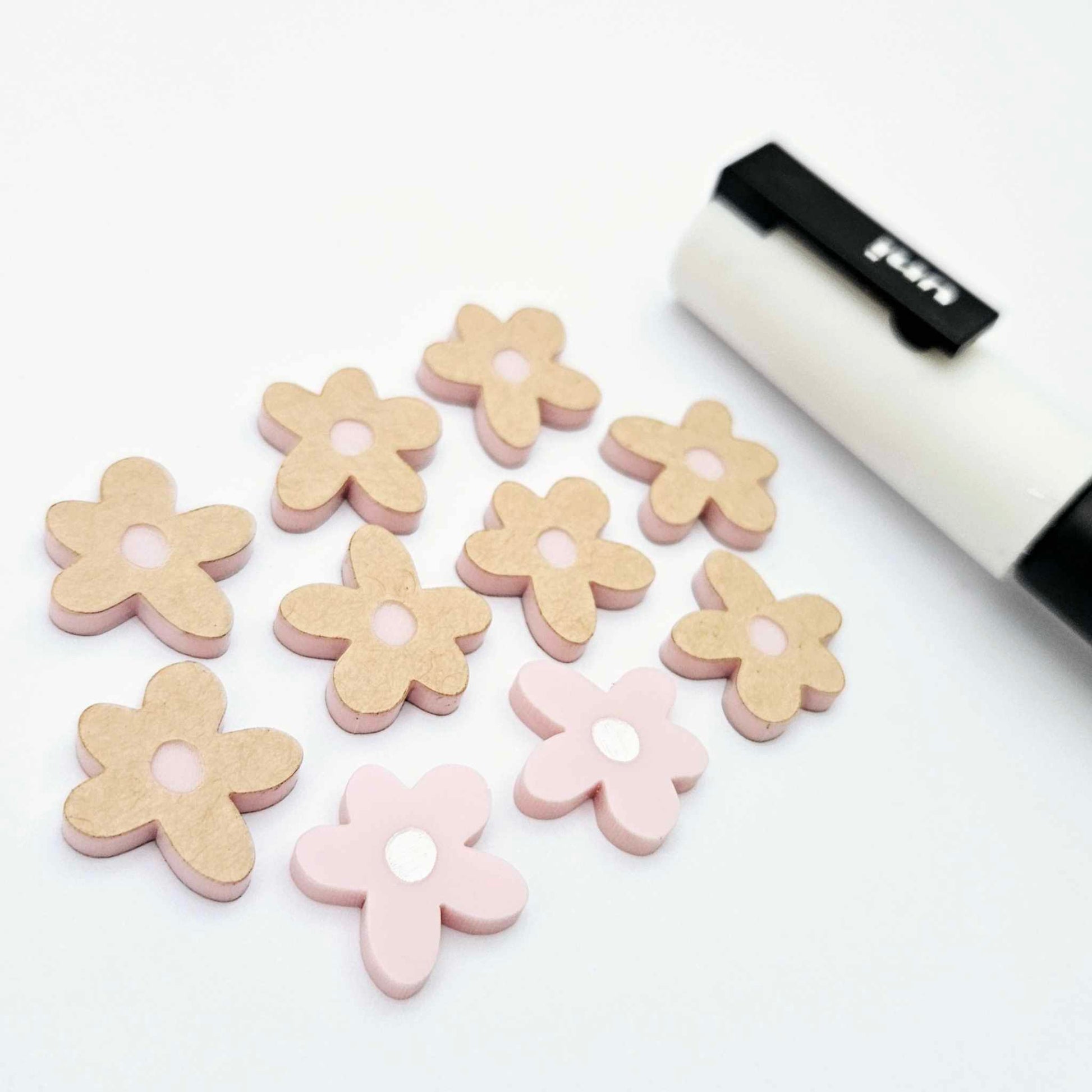 16mm dusty pale pink organic flower stud blanks showing paint filled white example and unfilled pieces with protective film, pictured with a white Posca paint pen