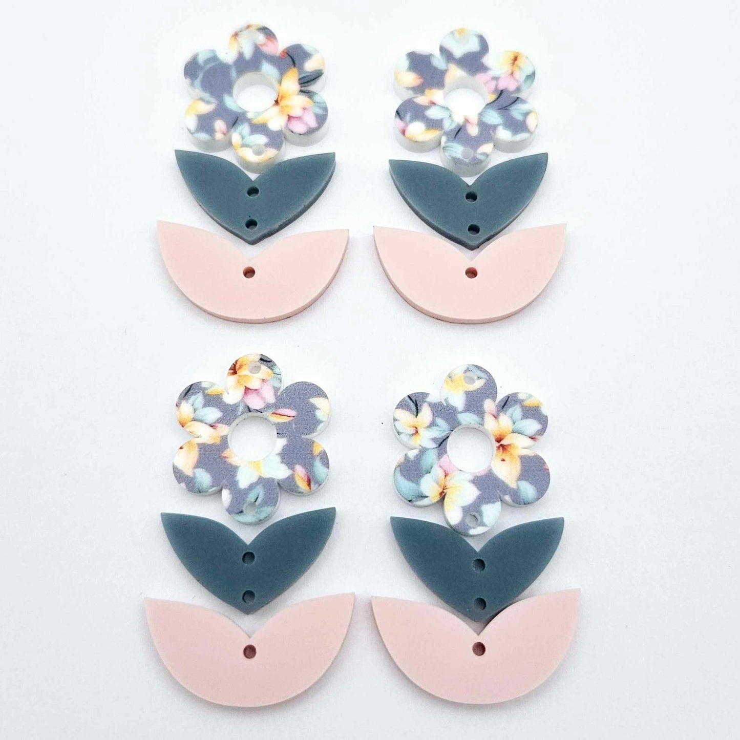Three-piece acrylic flower dangle blanks shown unassembled laying flat, featuring Hawaii Dream UV printed flower, bluestone leafy middle and strawberry milkshake leafy bottom