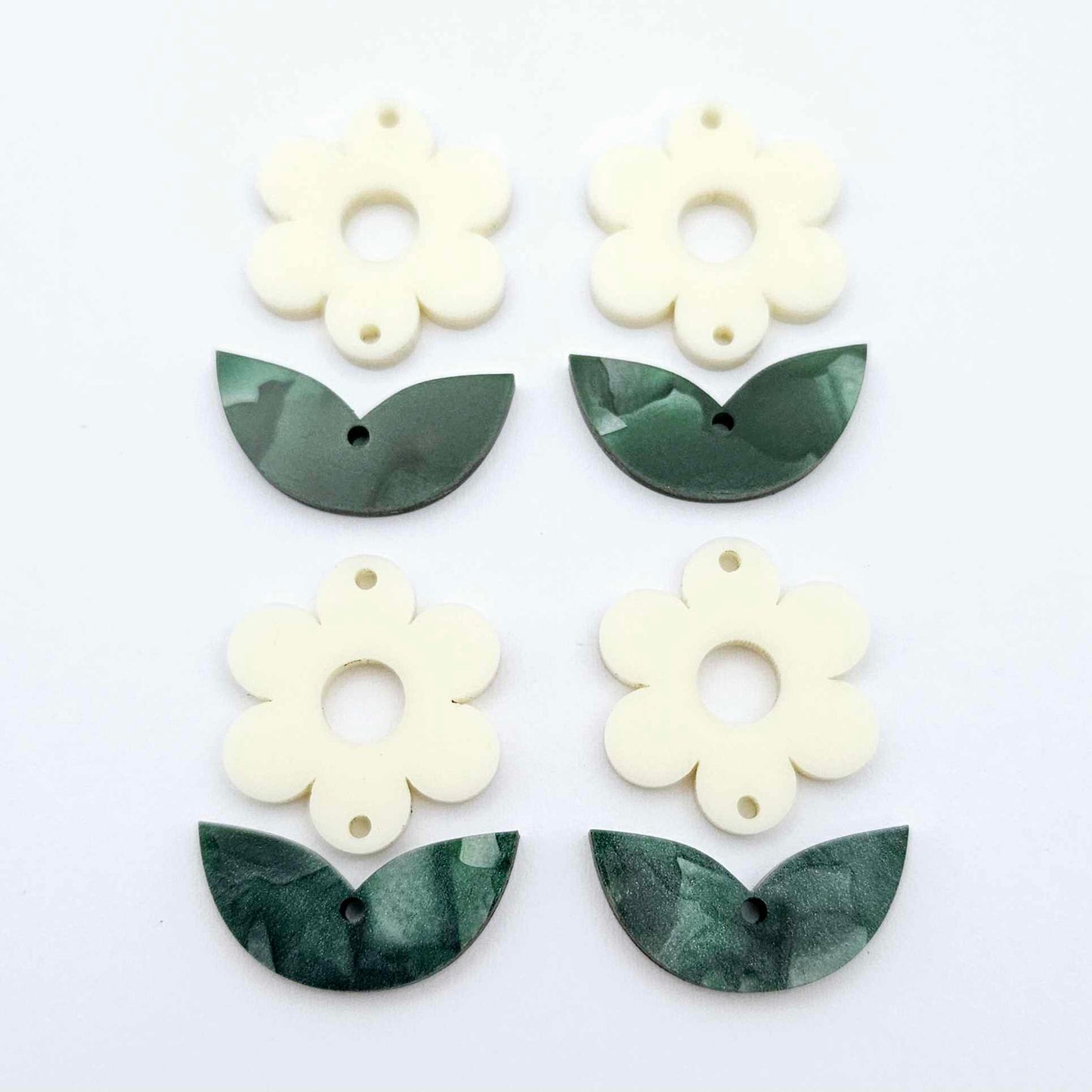 Two-piece cream flower and green mineral leafy dangle blanks shown unassembled and laying flat to display the full 31mm floral design