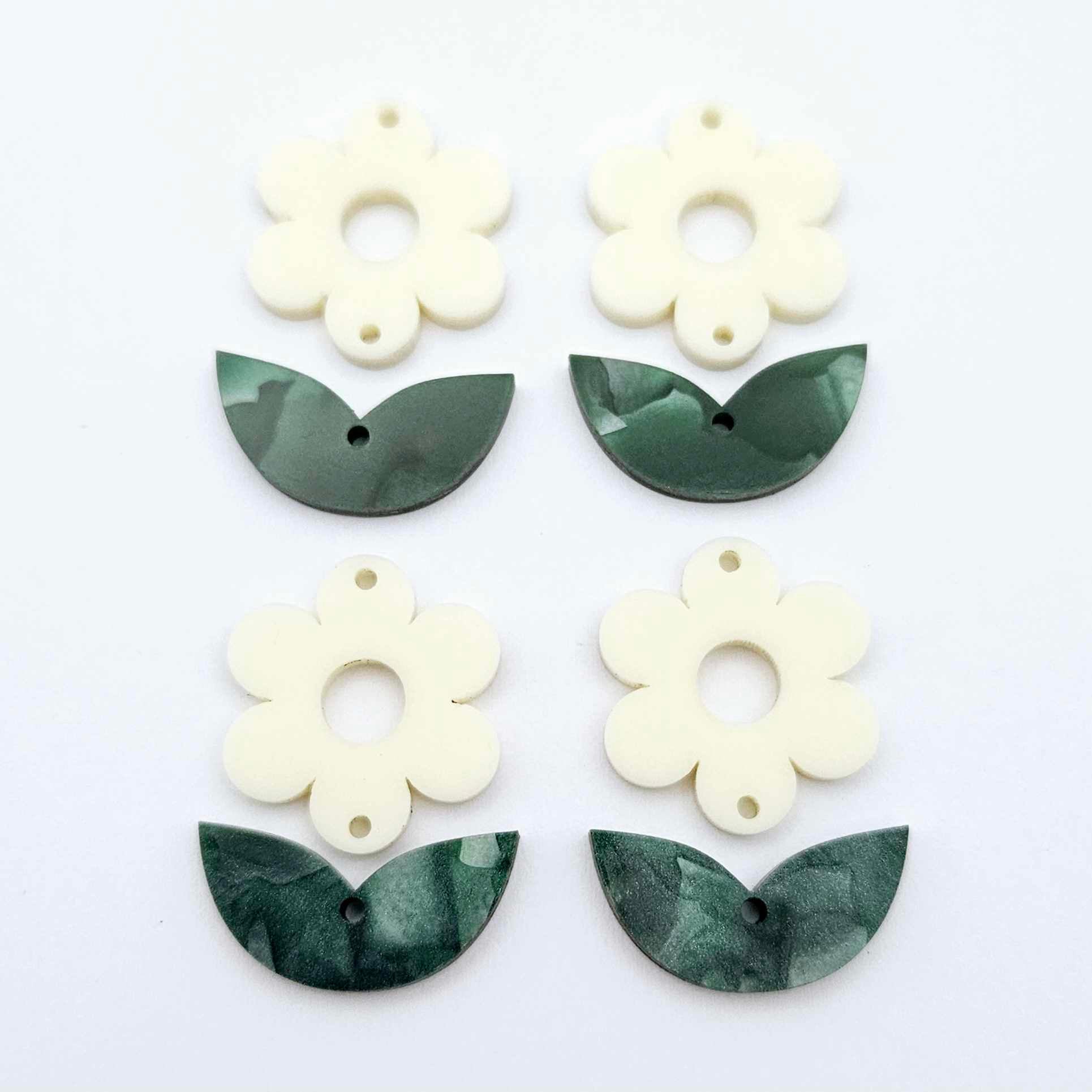 Two-piece cream flower and green mineral leafy dangle blanks shown unassembled and laying flat to display the full 31mm floral design