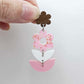 Assembled three-piece acrylic floral dangle hanging from a 14mm walnut flower topper, Cherry Blossom UV printed flower with white and pastel pink layered leaf pieces