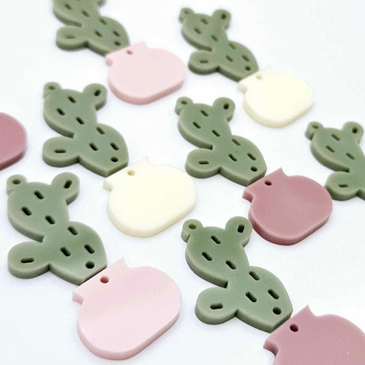 Two-piece acrylic cactus dangle blanks in olive green with mixed coloured pots, shown unassembled with cactus top and pot bottom pieces laid flat