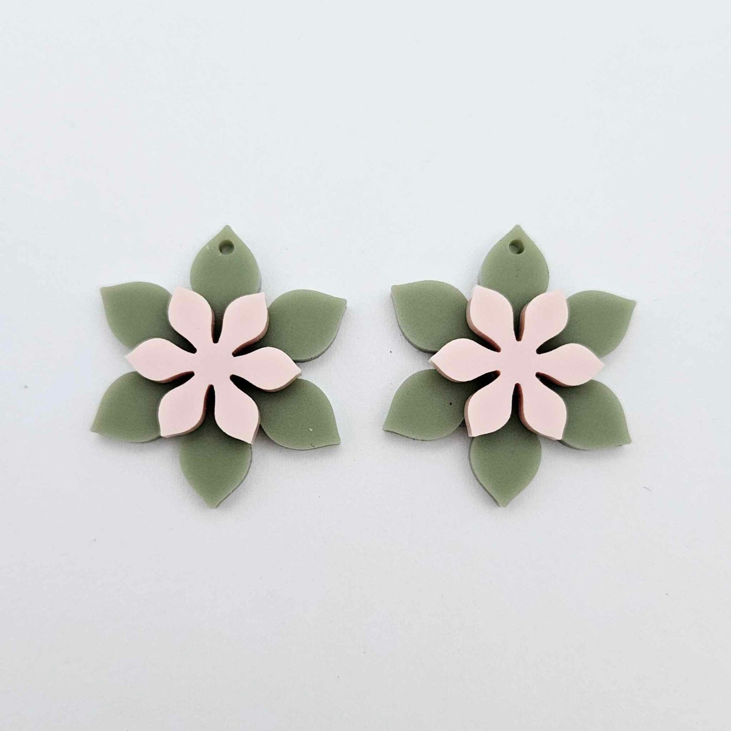 Olive Green and strawberry milkshake pink acrylic two layer flower dangle blanks shown laying flat, with flowers stacked to show layered effect