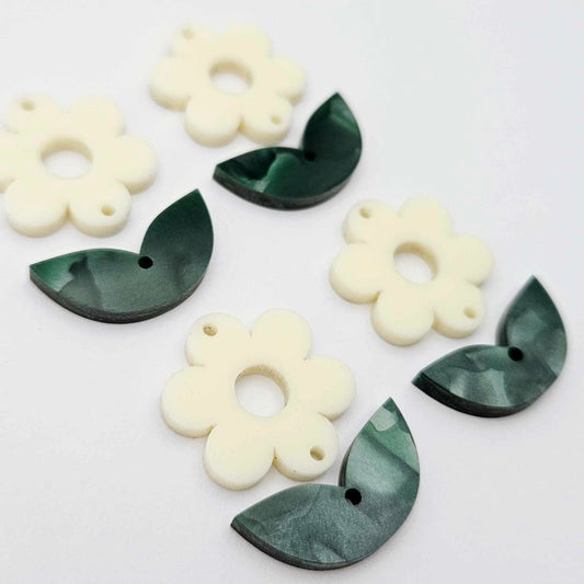 Two-piece cream flower and green mineral leafy dangle blanks shown unassembled and laying flat to display the full 31mm floral design