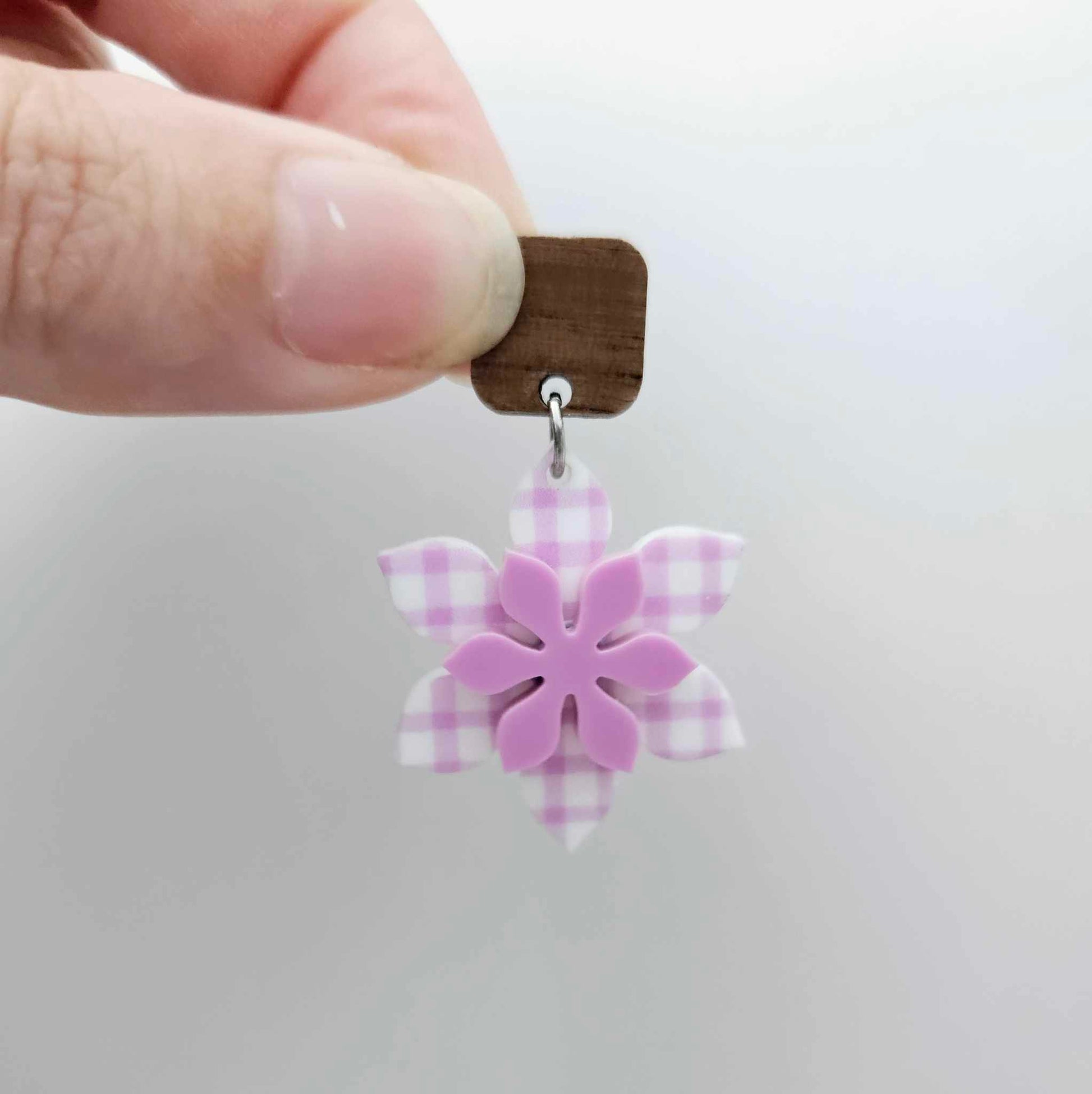 Layered purple gingham UV print and sour grape acrylic flower dangle assembled and hanging from a 12mm walnut wood topper, 3D two tone floral design