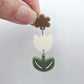 Cream and Olive Green acrylic tulip shape earring blanks shown with one of our iced coffee brown flower toppers