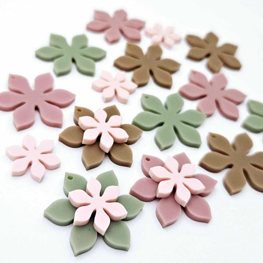 Olive Green, Iced Coffee Brown, Dusty Rose and strawberry milkshake pink acrylic two layer flower dangle blanks shown laying flat, with some flowers stacked to show layered effect and others positioned side by side