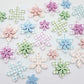 Gingham UV print and pastel acrylic two layer flower dangle blanks shown laying flat, with some flowers stacked to show layered effect and others positioned side by side