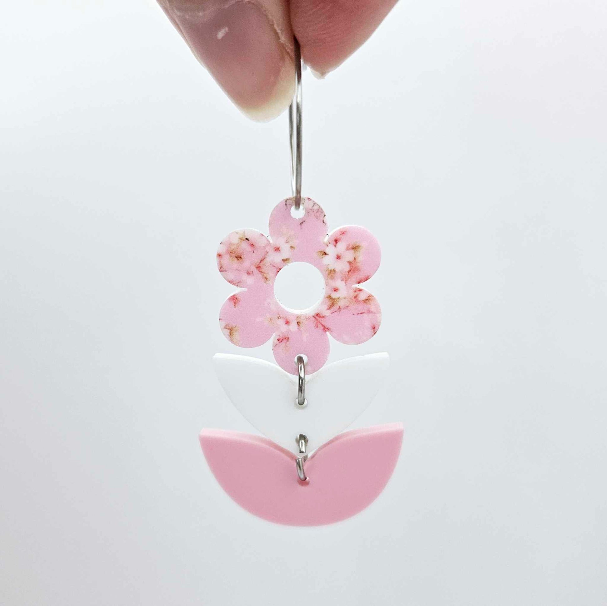 Assembled three-piece acrylic flower dangle hanging from a 20mm hoop, UV printed Cherry Blossom flower with white and pastel pink leaf layers