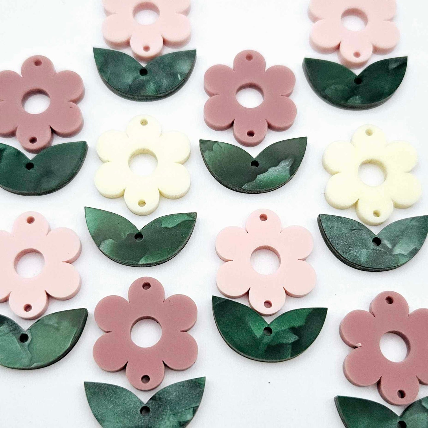 Two-piece flower and green mineral acrylic leafy dangle blanks shown unassembled and laying flat to display the full 31mm floral design