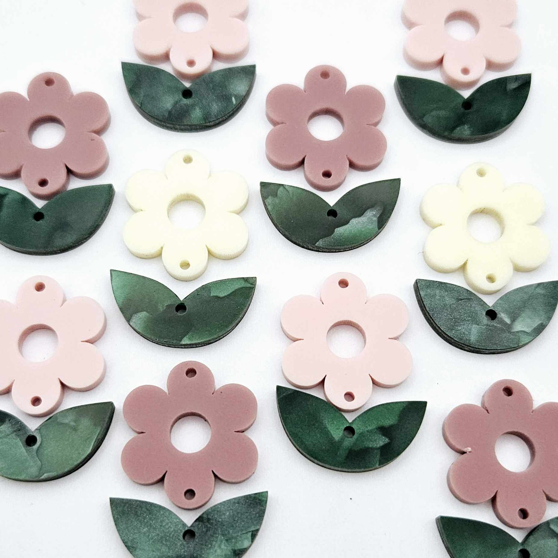 Two-piece flower and green mineral acrylic leafy dangle blanks shown unassembled and laying flat to display the full 31mm floral design
