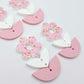 Three-piece acrylic flower dangle blanks shown unassembled laying flat, featuring Cherry Blosoom UV printed flower, white leafy middle and pastel pink leafy bottom