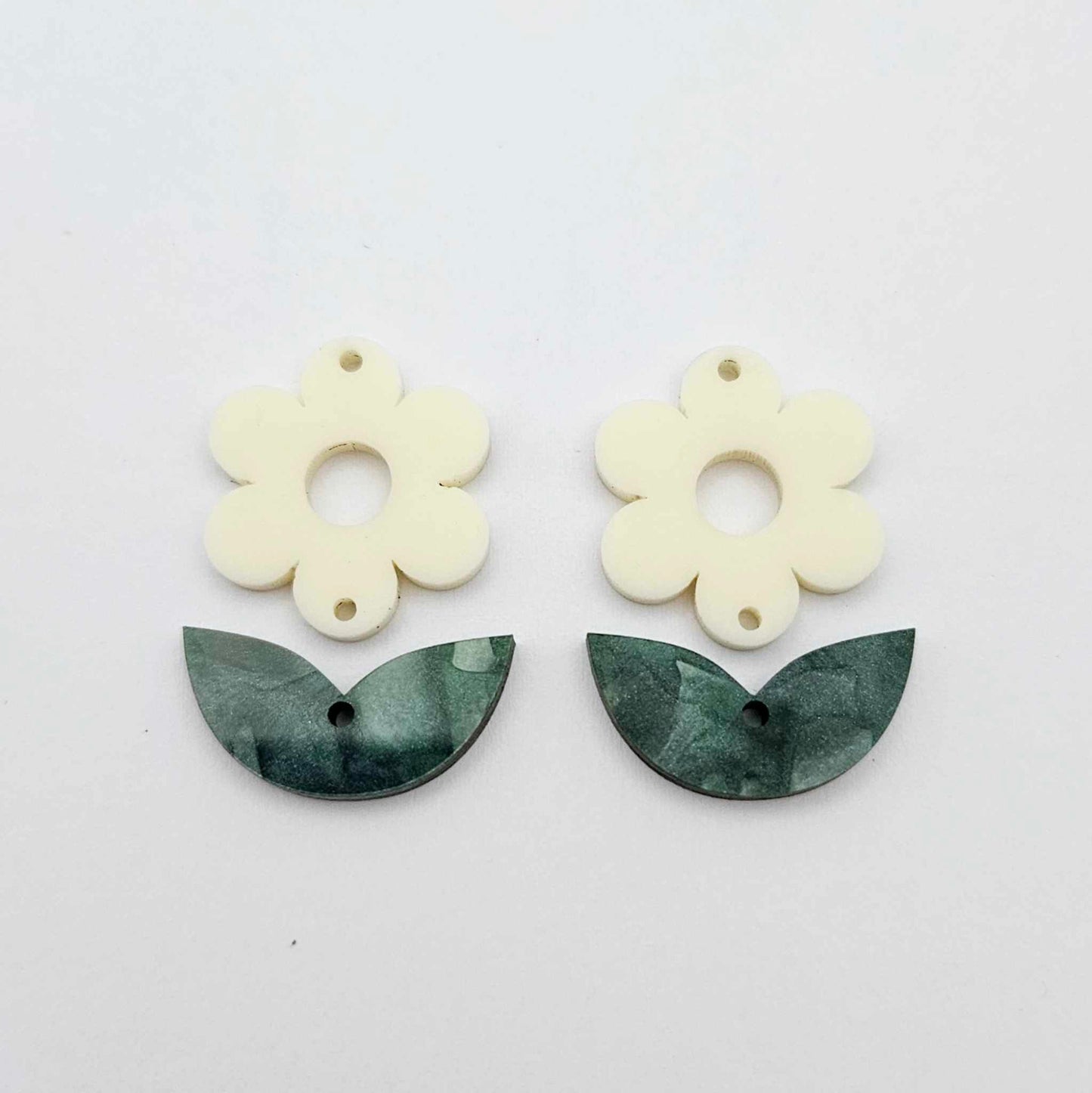 Two-piece cream flower and green mineral leafy dangle blanks shown unassembled and laying flat to display the full 31mm floral design