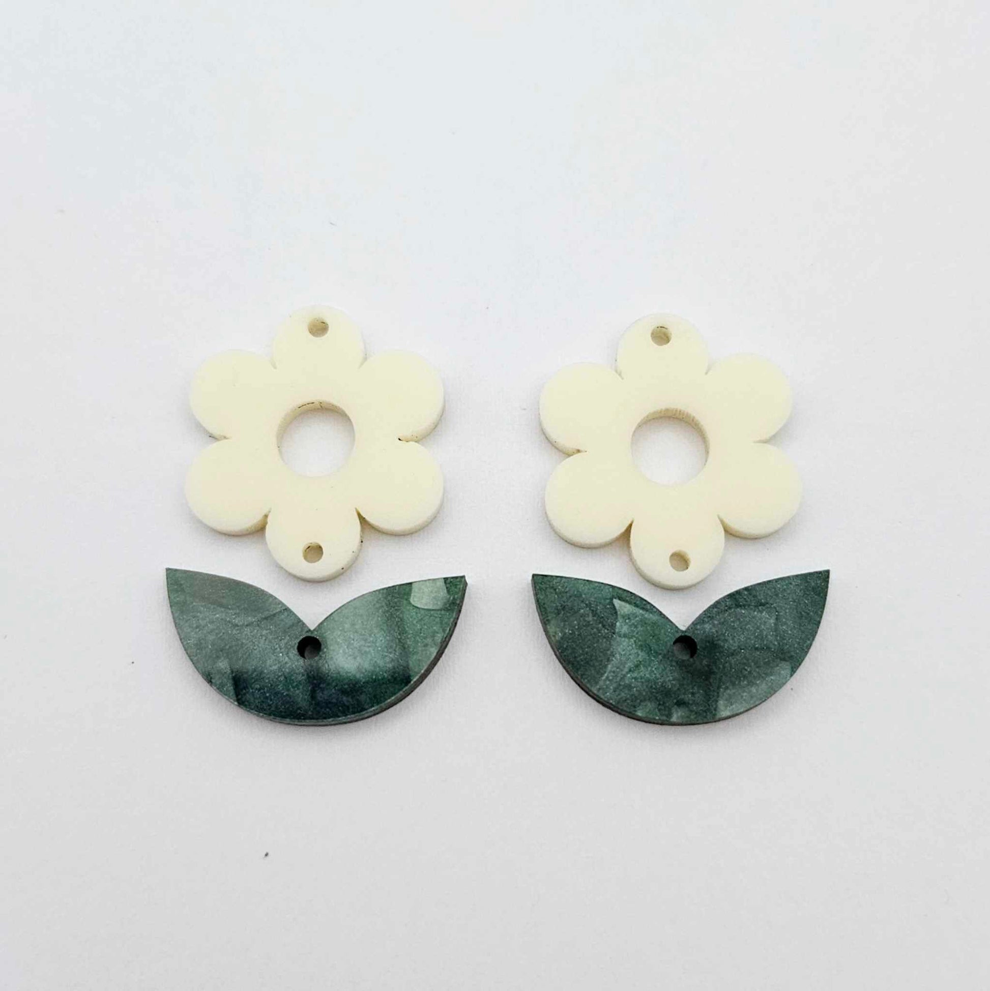 Two-piece cream flower and green mineral leafy dangle blanks shown unassembled and laying flat to display the full 31mm floral design