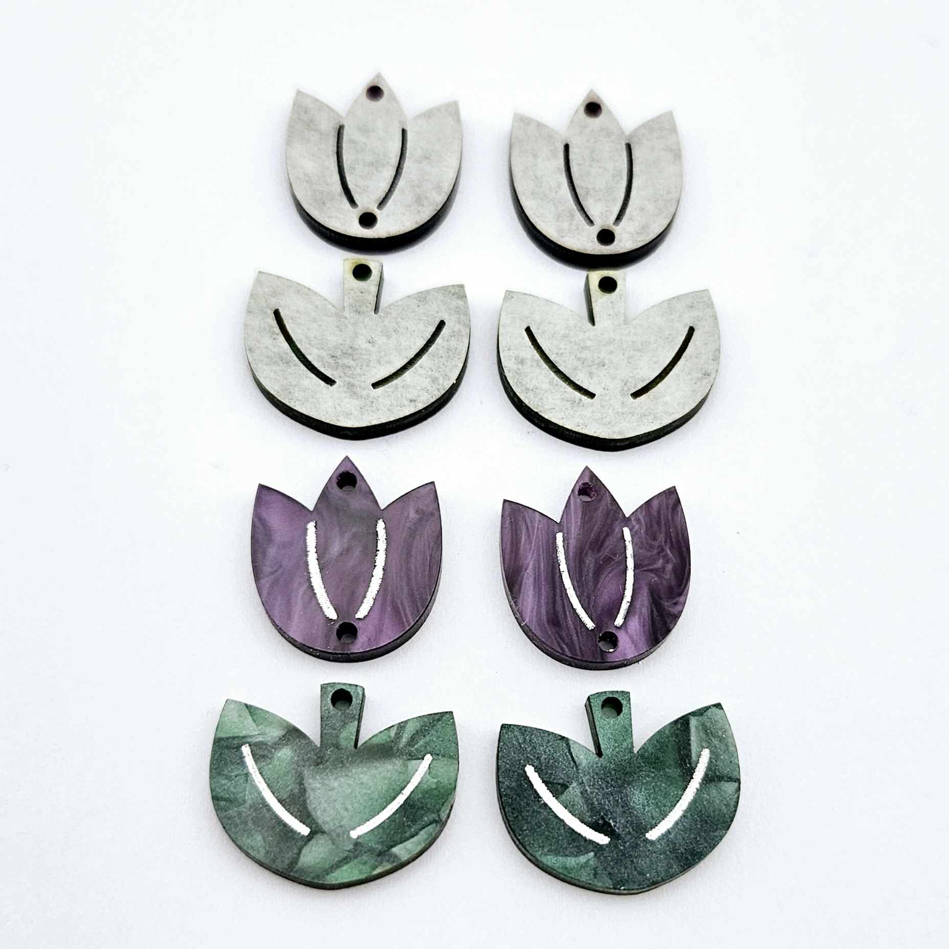 Two-piece tulip acrylic dangle blanks in purple marble and green mineral acrylic, paint filled white on one pair with remaining pair unfilled