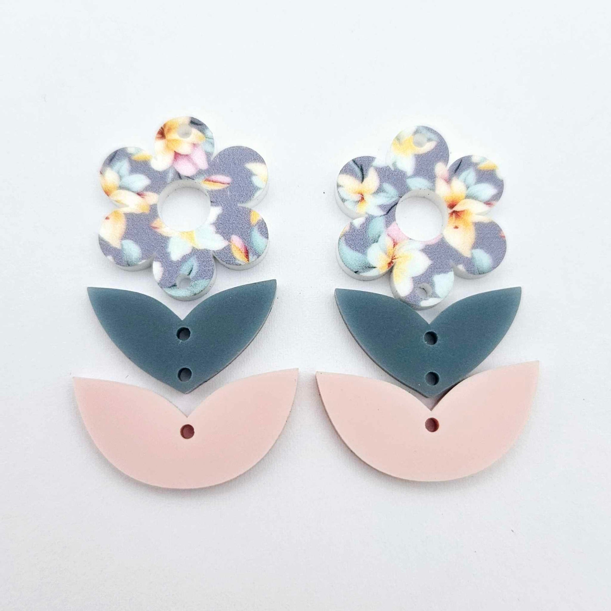 Three-piece acrylic flower dangle blanks shown unassembled laying flat, featuring Hawaii Dream UV printed flower, bluestone leafy middle and strawberry milkshake leafy bottom