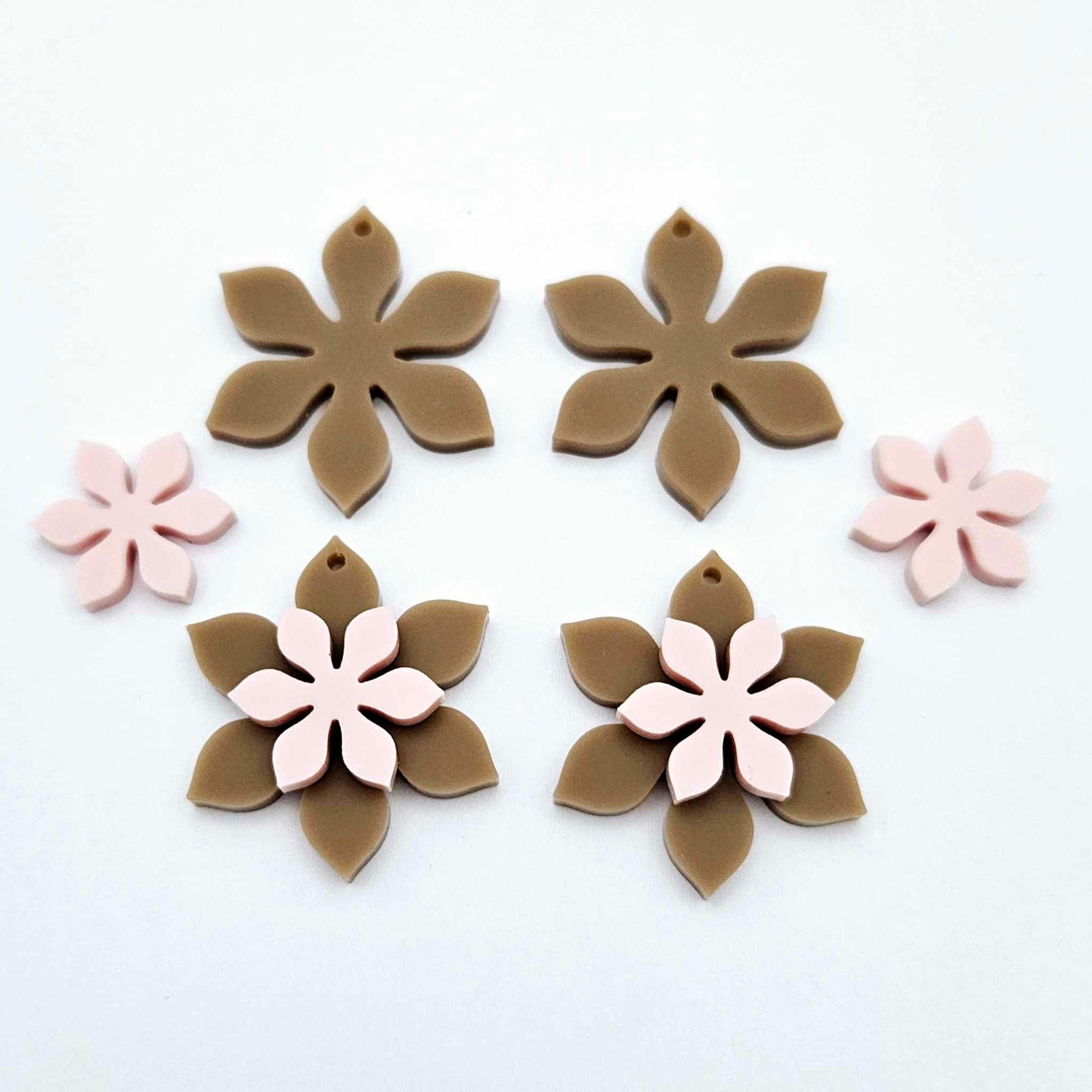 Iced Coffee Brown and strawberry milkshake pink acrylic two layer flower dangle blanks shown laying flat, with some flowers stacked to show layered effect and others positioned side by side
